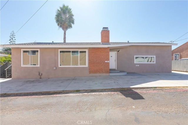 134 Palm Ave, National City, CA 91950 - rear view of property featuring stucco siding and a chimney