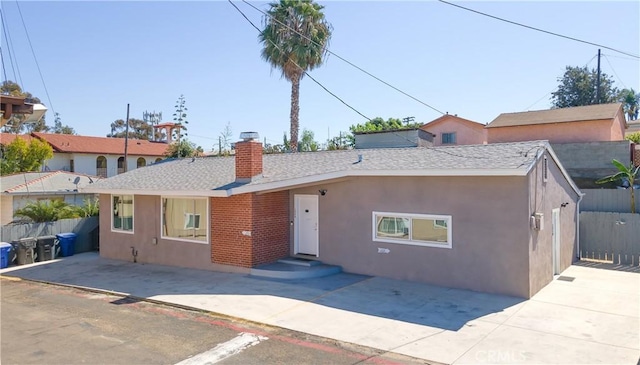 134 Palm Ave, National City, CA 91950 - view of front facade featuring stucco siding, a chimney, and a shingled roof