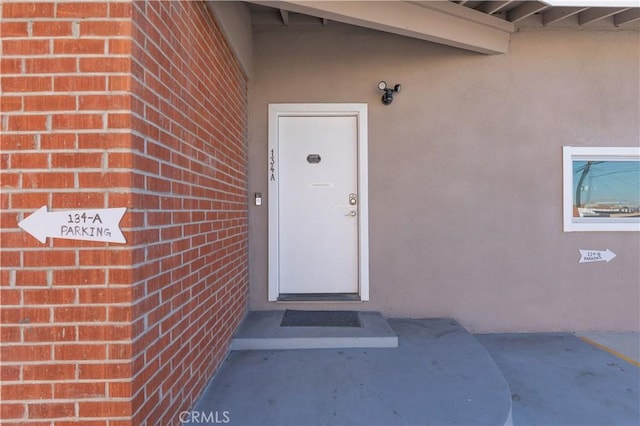134 Palm Ave, National City, CA 91950 - doorway to property featuring brick siding and stucco siding