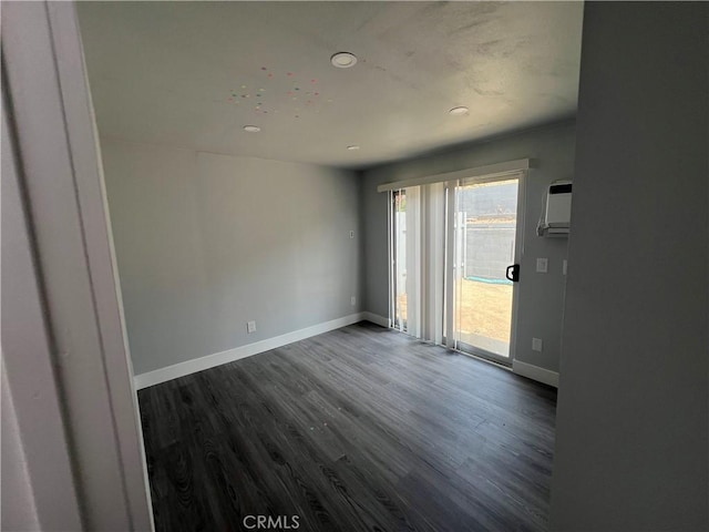 134 Palm Ave, National City, CA 91950 - empty room featuring dark wood-style floors, recessed lighting, baseboards, and a wall mounted AC