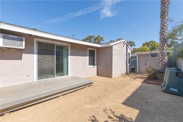 134 Palm Ave, National City, CA 91950 - back of property featuring stucco siding, an AC wall unit, and a deck