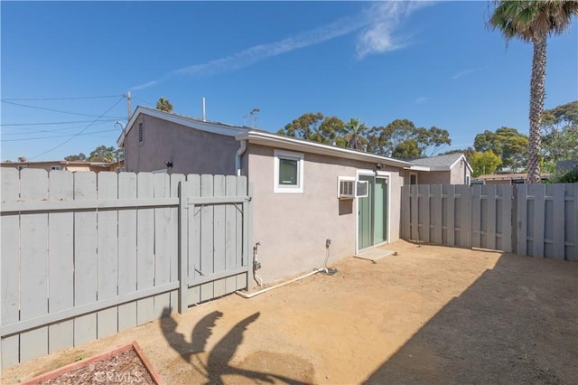 134 Palm Ave, National City, CA 91950 - rear view of house with stucco siding and a gate