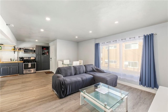 134 Palm Ave, National City, CA 91950 - living area featuring recessed lighting, light wood-style flooring, and baseboards