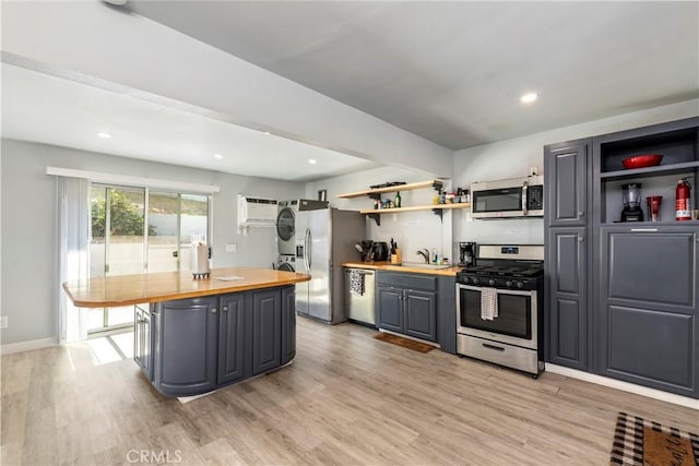 134 Palm Ave, National City, CA 91950 - kitchen featuring stainless steel appliances, wooden counters, stacked washer / drying machine, open shelves, and recessed lighting