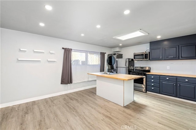 134 Palm Ave, National City, CA 91950 - kitchen featuring stainless steel appliances, butcher block countertops, stacked washer / drying machine, light wood-type flooring, and recessed lighting