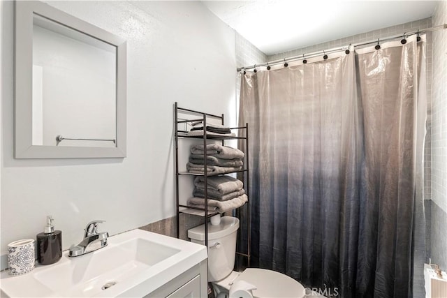 134 Palm Ave, National City, CA 91950 - full bath featuring toilet, vanity, a shower with curtain, and radiator heating unit