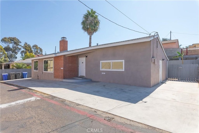 134 Palm Ave, National City, CA 91950 - single story home with a chimney, stucco siding, and a patio area