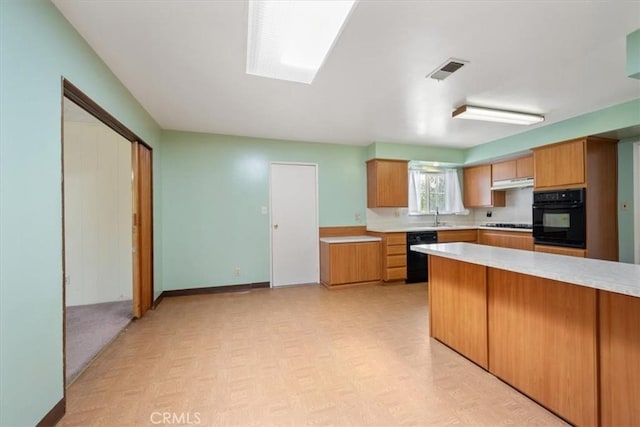 4038 Dartmouth Ln, Santa Maria, CA 93455 - kitchen with black appliances, light countertops, under cabinet range hood, baseboards, and tasteful backsplash