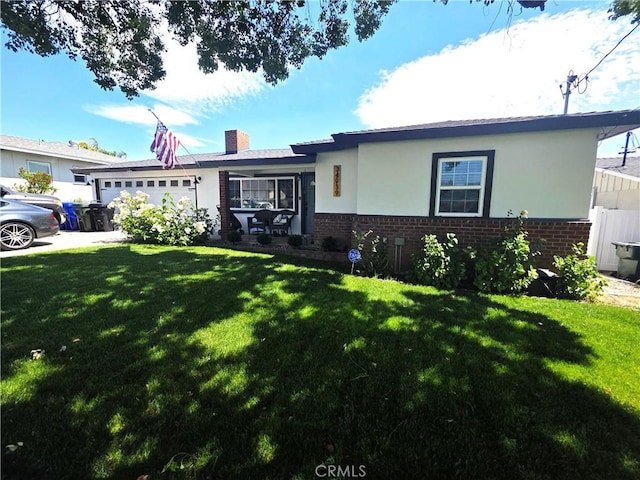 34939 Date Ave, Yucaipa, CA 92399 - ranch-style house with brick siding, a garage, and a front lawn