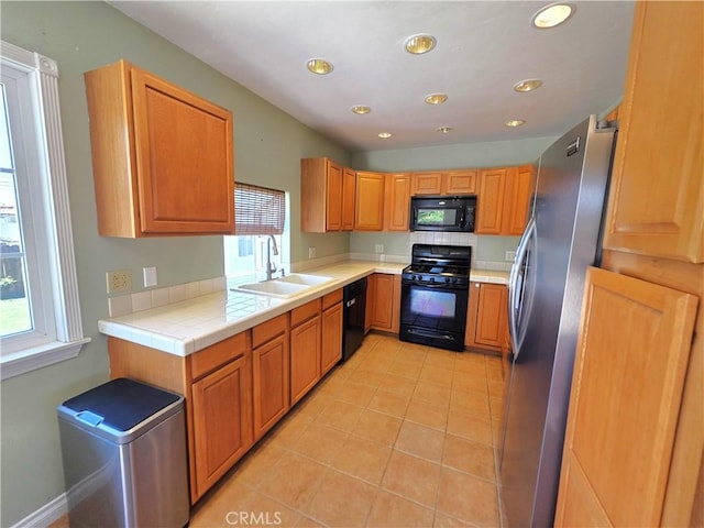 34939 Date Ave, Yucaipa, CA 92399 - kitchen with black appliances, plenty of natural light, light tile patterned flooring, recessed lighting, and tile counters