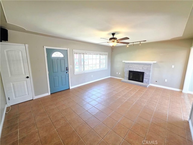 34939 Date Ave, Yucaipa, CA 92399 - unfurnished living room with ceiling fan, tile patterned flooring, a fireplace, and rail lighting