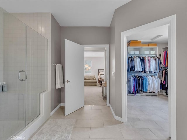 5637 Como Cir, Woodland Hills, CA 91367 - ensuite bathroom featuring a shower stall, tile patterned flooring, and a walk in closet