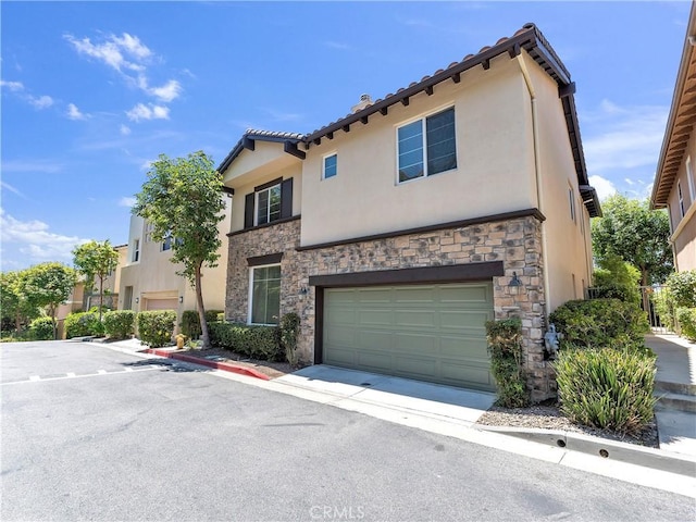 5637 Como Cir, Woodland Hills, CA 91367 - view of front of property featuring stone siding, stucco siding, a garage, and a tiled roof