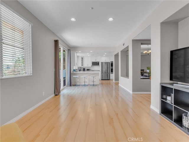 5637 Como Cir, Woodland Hills, CA 91367 - unfurnished living room with recessed lighting, a chandelier, and light wood-type flooring