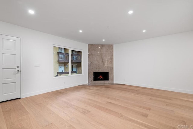 1680 N Coast Highway 101 Unit 36, Encinitas, CA 92024 - unfurnished living room featuring recessed lighting, light wood finished floors, and a fireplace