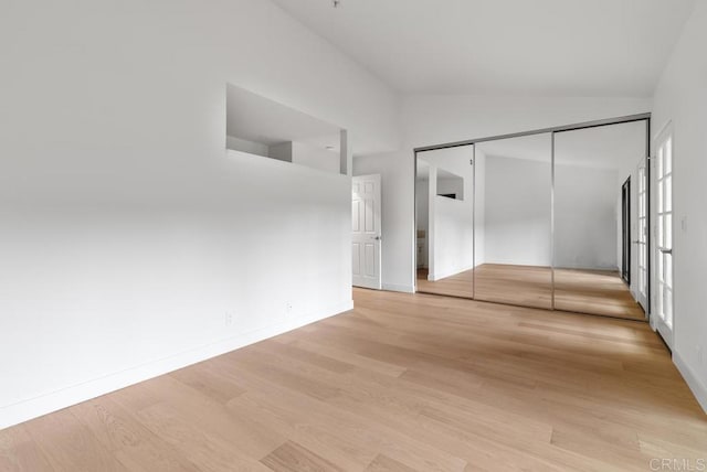 1680 N Coast Highway 101 Unit 36, Encinitas, CA 92024 - unfurnished bedroom with lofted ceiling, light wood finished floors, and a closet