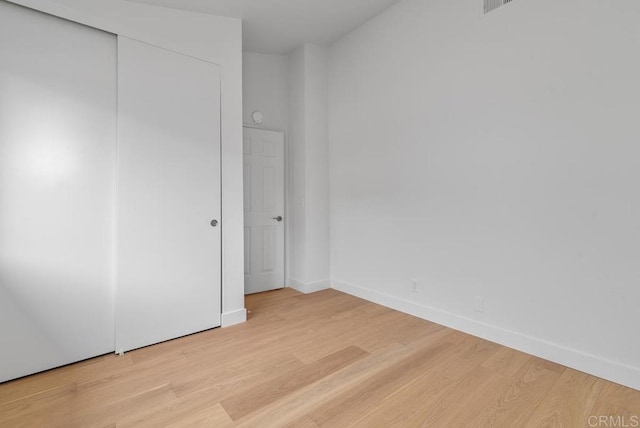 1680 N Coast Highway 101 Unit 36, Encinitas, CA 92024 - unfurnished bedroom featuring light wood finished floors and a closet