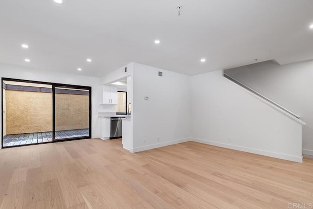 1680 N Coast Highway 101 Unit 36, Encinitas, CA 92024 - unfurnished living room with light wood-type flooring and recessed lighting