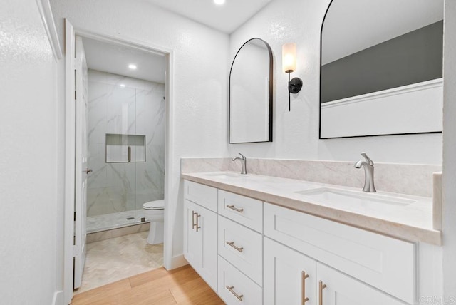 1680 N Coast Highway 101 Unit 36, Encinitas, CA 92024 - full bathroom featuring a marble finish shower, double vanity, wood finished floors, and recessed lighting