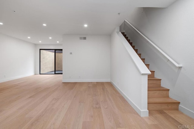 1680 N Coast Highway 101 Unit 36, Encinitas, CA 92024 - unfurnished living room with stairway, light wood-style floors, and recessed lighting