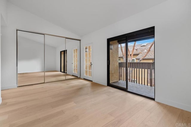 1680 N Coast Highway 101 Unit 36, Encinitas, CA 92024 - unfurnished bedroom with access to outside, wood finished floors, lofted ceiling, french doors, and a closet