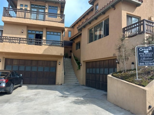 121 Loma Ln, San Clemente, CA 92672 - view of property with a garage, stairs, and concrete driveway