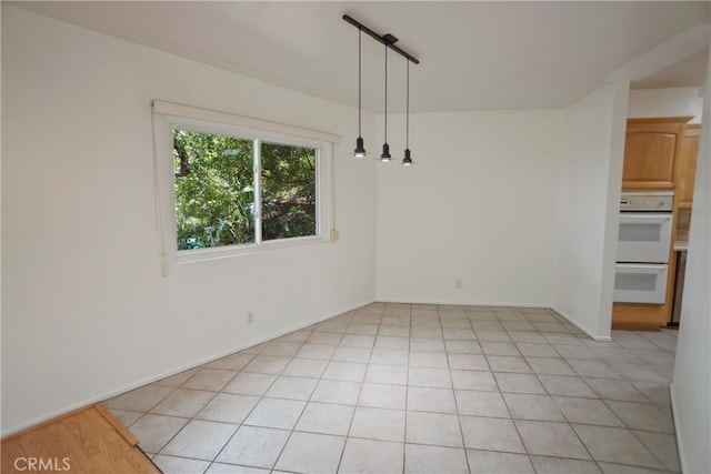 4182 Sunswept Dr, Studio City, CA 91604 - unfurnished dining area with light tile patterned floors and baseboards