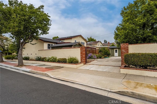 2902 E Trenton E, Orange, CA 92867 - view of front facade featuring stucco siding and driveway