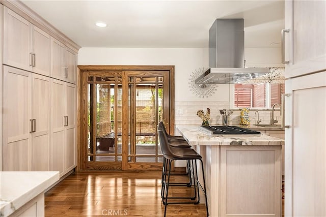 2902 E Trenton E, Orange, CA 92867 - kitchen with extractor fan, stainless steel gas cooktop, decorative backsplash, wood finished floors, and a kitchen bar