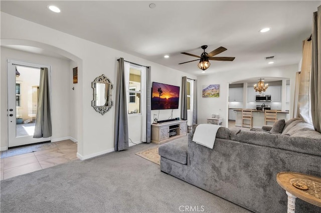 7988 Borrego Ct, Yucca Valley, CA 92284 - living area with arched walkways, baseboards, a chandelier, ceiling fan, and light carpet