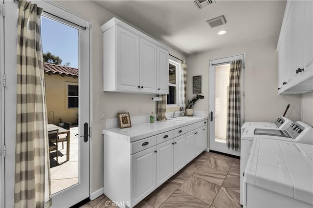 7988 Borrego Ct, Yucca Valley, CA 92284 - laundry area with washer and dryer, cabinet space, recessed lighting, and light marble finish flooring