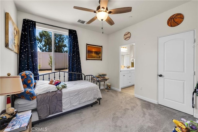 7988 Borrego Ct, Yucca Valley, CA 92284 - carpeted bedroom featuring baseboards, ensuite bath, and a ceiling fan