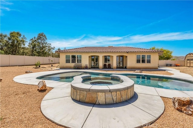 7988 Borrego Ct, Yucca Valley, CA 92284 - view of pool featuring french doors, a fenced backyard, a patio area, and a pool with connected hot tub