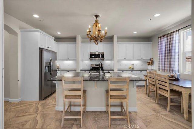 7988 Borrego Ct, Yucca Valley, CA 92284 - kitchen featuring stainless steel appliances, tasteful backsplash, a chandelier, white cabinetry, and recessed lighting