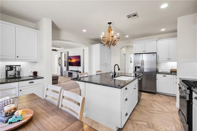7988 Borrego Ct, Yucca Valley, CA 92284 - kitchen with a sink, arched walkways, appliances with stainless steel finishes, a chandelier, and recessed lighting