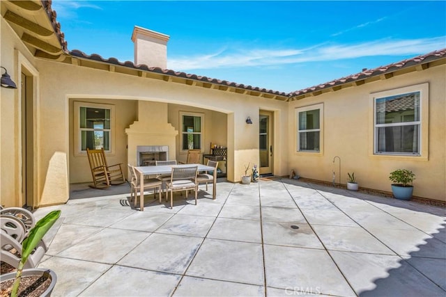 7988 Borrego Ct, Yucca Valley, CA 92284 - view of patio featuring an outdoor fireplace and outdoor dining area