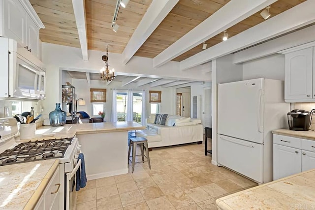 181719 Coast Blvd, Del Mar, CA 92014 - kitchen with white appliances, track lighting, open floor plan, wood ceiling with exposed beams, and white cabinetry