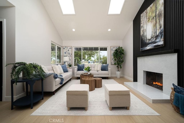11217 Stonecress Ave, Fountain Valley, CA 92708 - living room with high vaulted ceiling, a tiled fireplace, wood finished floors, recessed lighting, and baseboards