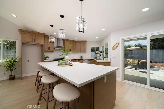 11217 Stonecress Ave, Fountain Valley, CA 92708 - kitchen with wall chimney range hood, light wood-style floors, light countertops, healthy amount of natural light, and recessed lighting