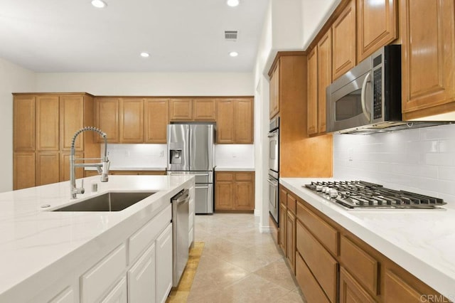 2413 Paseo, Los Gatos, Chula Vista, CA 91914 - kitchen featuring appliances with stainless steel finishes, light stone countertops, tasteful backsplash, recessed lighting, and brown cabinetry