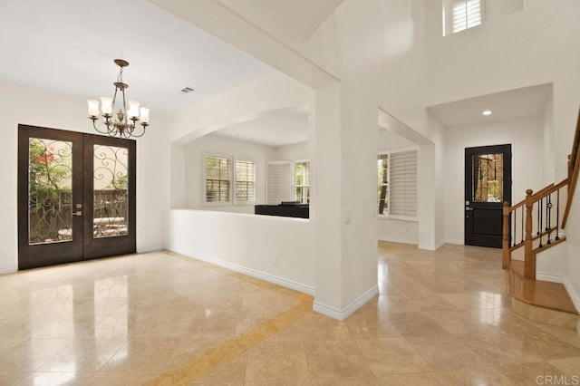 2413 Paseo, Los Gatos, Chula Vista, CA 91914 - foyer entrance with a chandelier, stairway, light tile patterned floors, french doors, and arched walkways