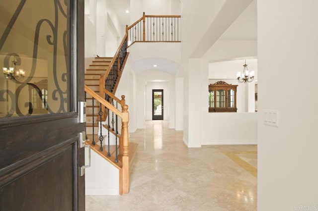 2413 Paseo, Los Gatos, Chula Vista, CA 91914 - foyer featuring a chandelier, stairway, arched walkways, and a towering ceiling