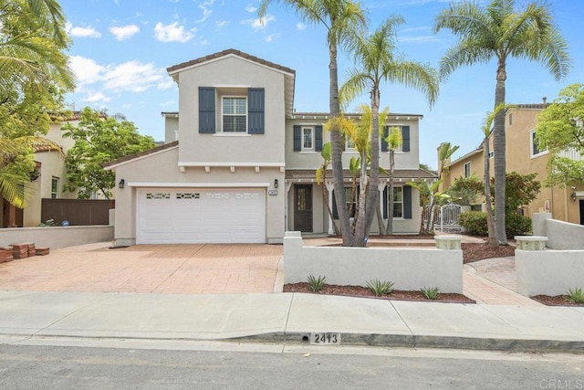 2413 Paseo, Los Gatos, Chula Vista, CA 91914 - view of front facade featuring stucco siding, a garage, and decorative driveway