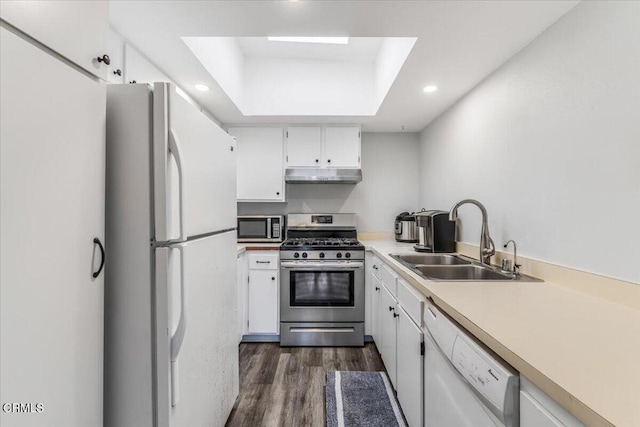 5206 Longfellow Way, Oxnard, CA 93033 - kitchen with appliances with stainless steel finishes, under cabinet range hood, a sink, dark wood-type flooring, and white cabinets