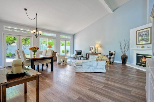 3376 Corsica Way, Oceanside, CA 92056 - living room with wood finished floors, a chandelier, high vaulted ceiling, a glass covered fireplace, and baseboards