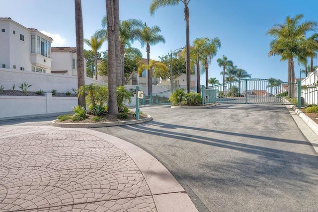 3376 Corsica Way, Oceanside, CA 92056 - view of asphalt road with a gate, a residential view, curbs, and a gated entry