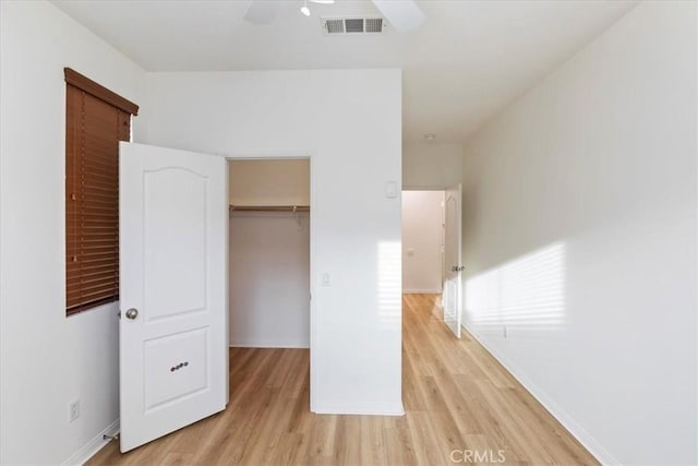 21567 Coral Rock Ln, Wildomar, CA 92595 - unfurnished bedroom with light wood finished floors, baseboards, a closet, a ceiling fan, and a spacious closet