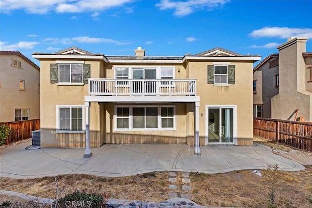 21567 Coral Rock Ln, Wildomar, CA 92595 - rear view of property with a balcony, stucco siding, a fenced backyard, a patio, and central AC unit