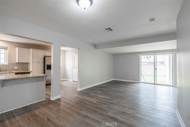 10113 Harvest Ave, Santa Fe Springs, CA 90670 - unfurnished living room with baseboards and dark wood-style floors