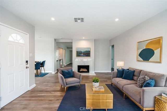 10113 Harvest Ave, Santa Fe Springs, CA 90670 - living area featuring wood finished floors, baseboards, recessed lighting, and a high end fireplace